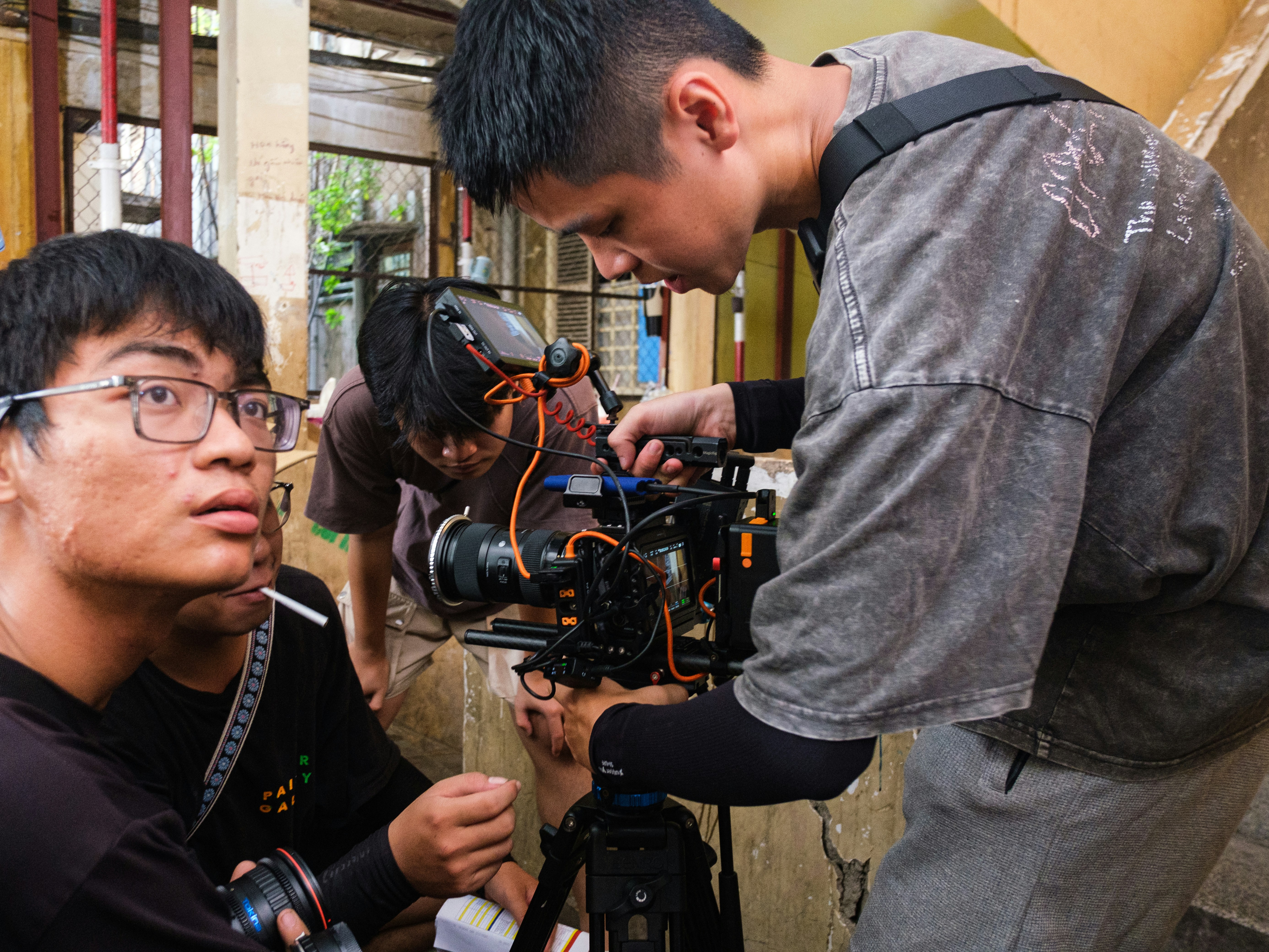 Filmmakers adjusting a professional camera on set